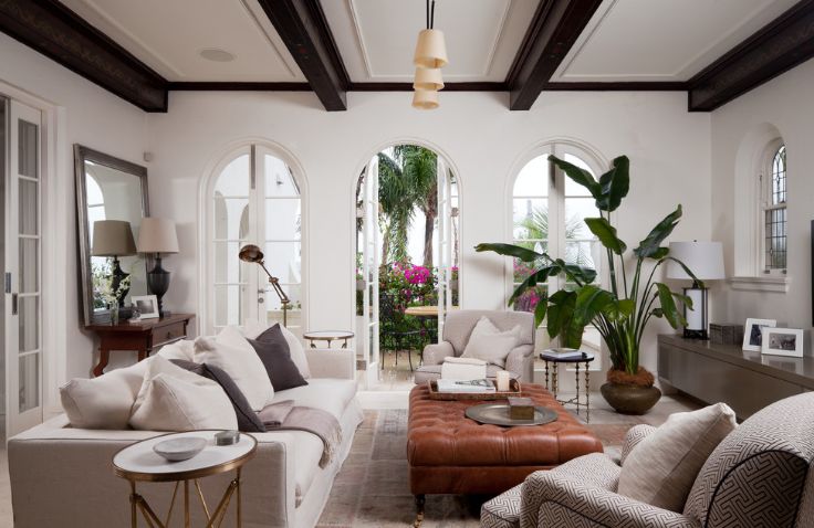 White walls and black beams living room with tall plants in corner