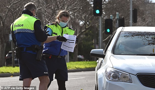 Victoria could remain in lockdown for another five months, according to government modelling. Pictured: Police pull a car over for a licence and permit check in Melbourne on Tuesday